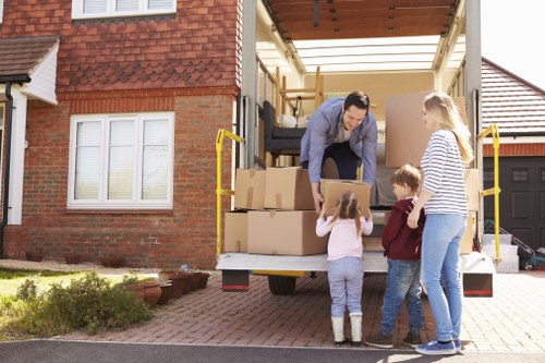 Moving boxes and furniture during a Removals Holland Park service