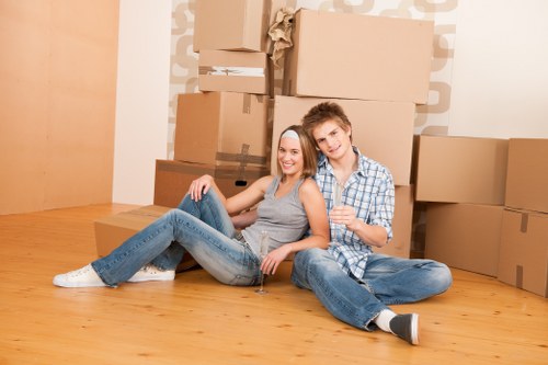 Professional movers handling furniture and boxes for a Holland Park home