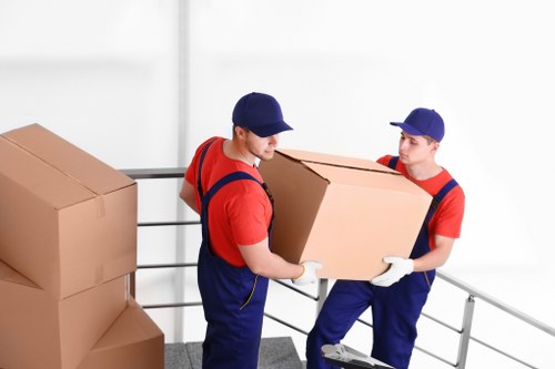 Moving boxes and protected furniture prepared for a Holland Park relocation