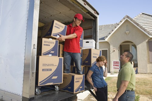 Furniture and boxes being transported during a Holland Park removal
