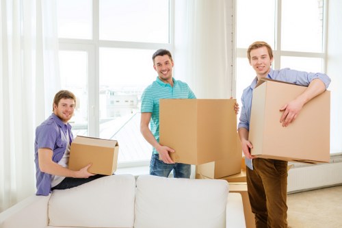 A moving team handling furniture in a stylish Holland Park property