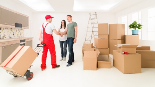 Careful loading of unwanted furniture for collection in Holland Park