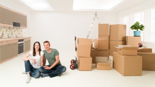 Furniture being carefully loaded during a same day home move in Holland Park