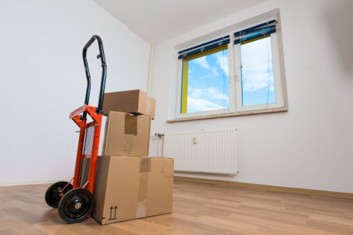 Removals team navigating stairs in a West London flat