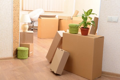 Office movers handling desks, equipment, and boxes in Holland Park